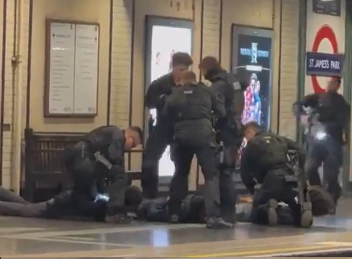 Armed Met Police officers arresting three suspects at a London Tube station, with a city map in the background highlighting the location of the incident, showcasing the police's swift action and commitment to law enforcement