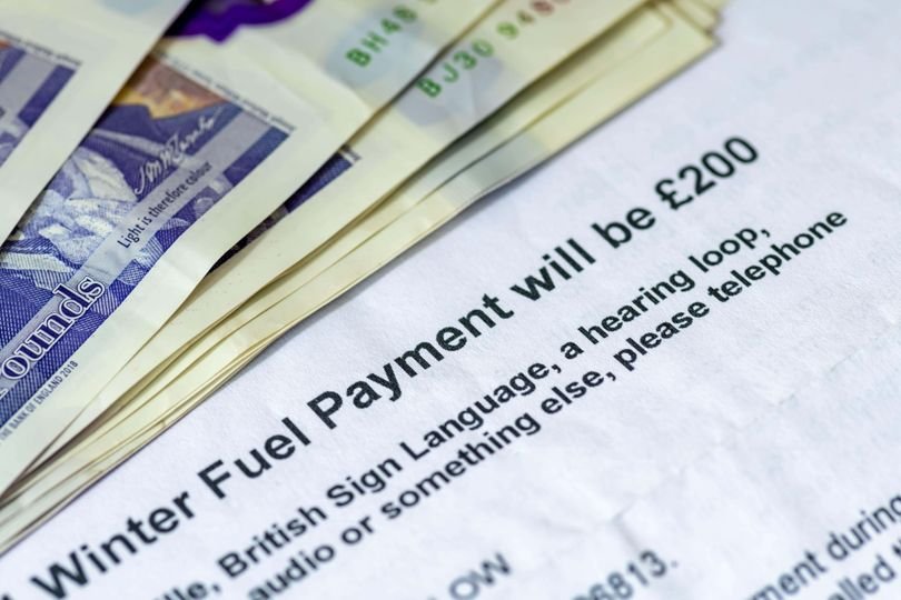 A senior citizen looking at a letter from the HMRC, with a concerned expression, highlighting the £33 charge for state pensioners and the importance of understanding the implications of the Pension Credit scheme.