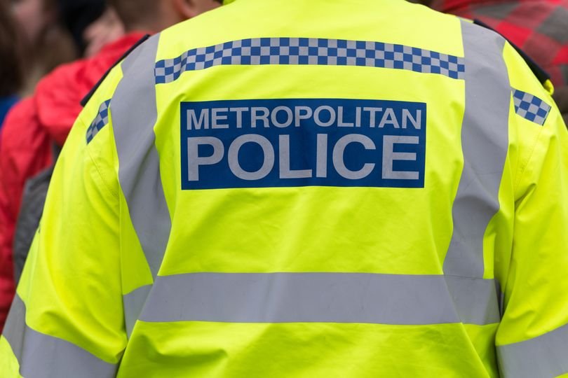 A teenager being rushed to hospital after being stabbed outside a London Underground station in broad daylight, with police officers and paramedics at the scene, highlighting the need for increased safety measures in the city