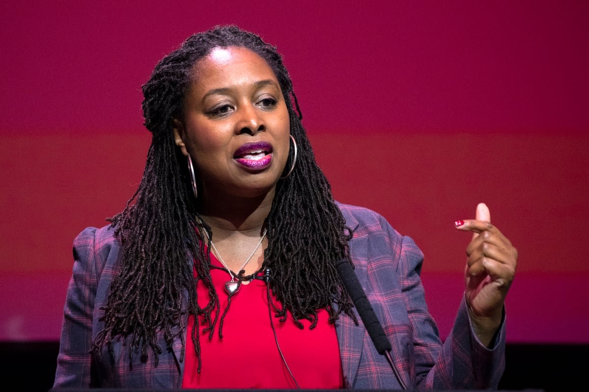 Dawn Butler, Labour's London Mayoral candidate, speaking at a public event with a crowd of supporters in the background, highlighting her commitment to the city and its people, with a focus on the London Mayor election