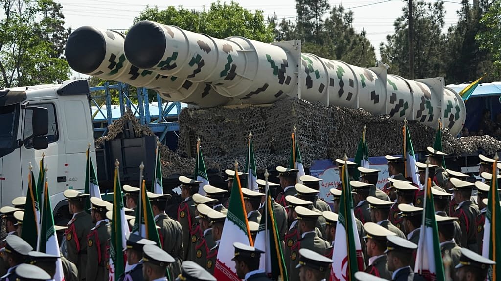 Iranian military personnel and equipment, with a focus on the primary keyword of 'Iran war', as the country prepares for a potential conflict, with neighbouring countries on high alert and the international community urging calm and restraint