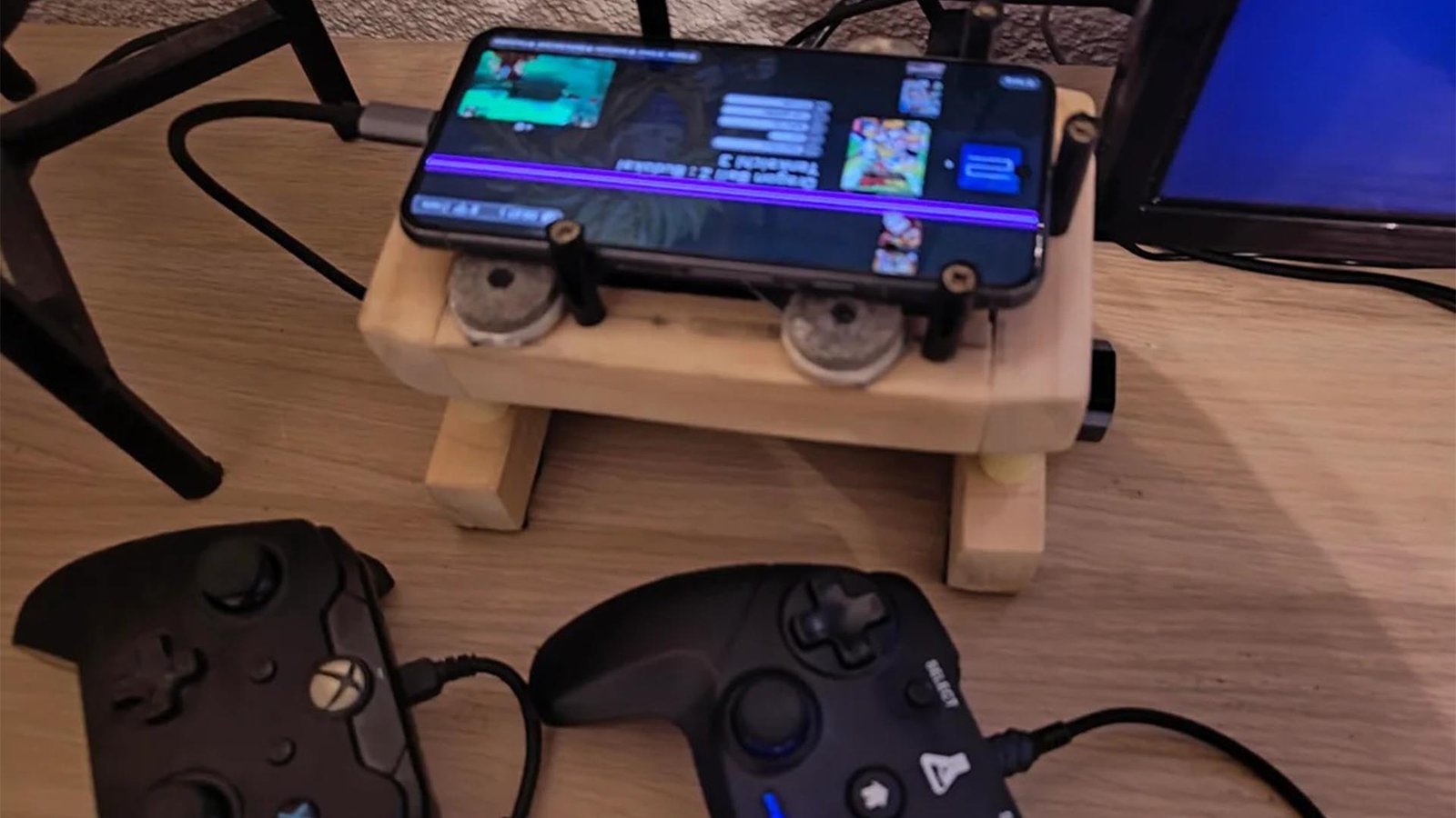 A damaged Pixel 8 converted into a playable console with multiple controllers and a cooling fan, showcasing creative reuse and repair in the UK