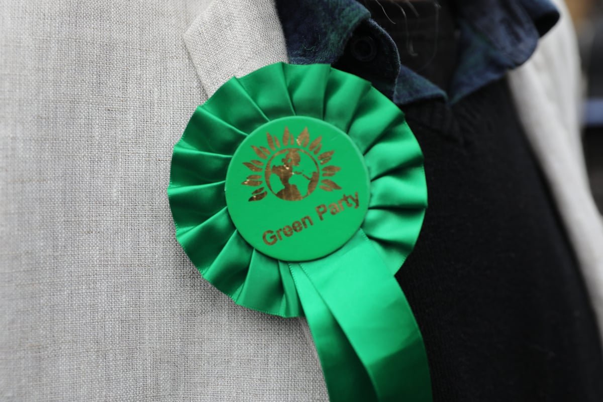 A descriptive image of the London cityscape with a focus on the Green Party's logo, highlighting the controversy surrounding the councillor resignations and the £120,000 bill, with a natural inclusion of the primary keyword phrase 'Green Party'