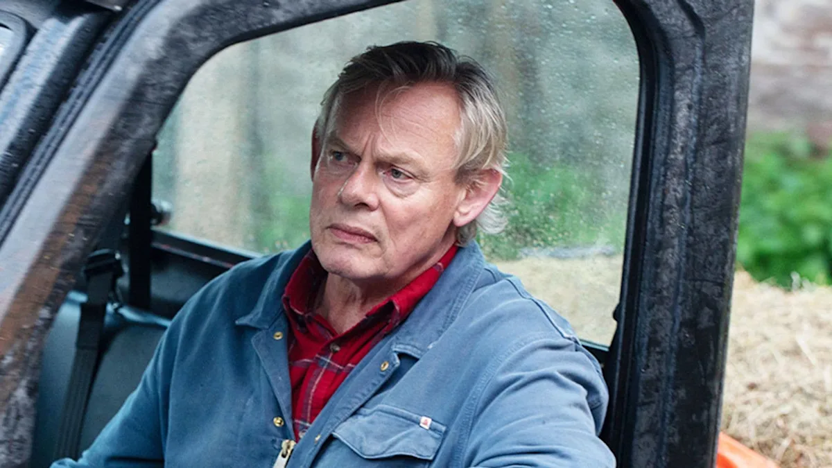 Martin Clunes on his Dorset farm, surrounded by rolling hills and vibrant green colour, a serene and peaceful backdrop to his life as a farmer and actor, with a focus on the tragic loss and his touching gesture