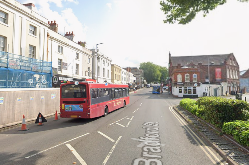 A Walsall school on lockdown after a nearby robbery with a weapons threat, with police cars and officers outside the school building, highlighting the importance of school safety and security