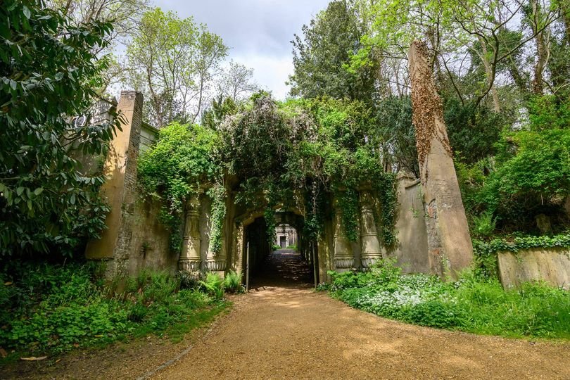 A serene and picturesque view of Highgate Cemetery, with its stunning architecture and intricate stone carvings, set amidst a tranquil atmosphere, where legendary figures like George Michael are laid to rest, and visitors can explore its winding paths and discover its fascinating stories