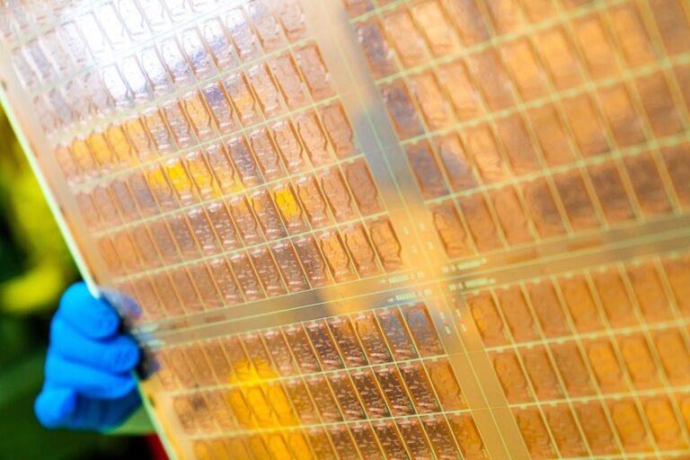 A close-up of a glass core substrate-based chip with an Active Optical Package, showcasing the intricate details of this innovative technology, which is set to transform the UK's technological landscape