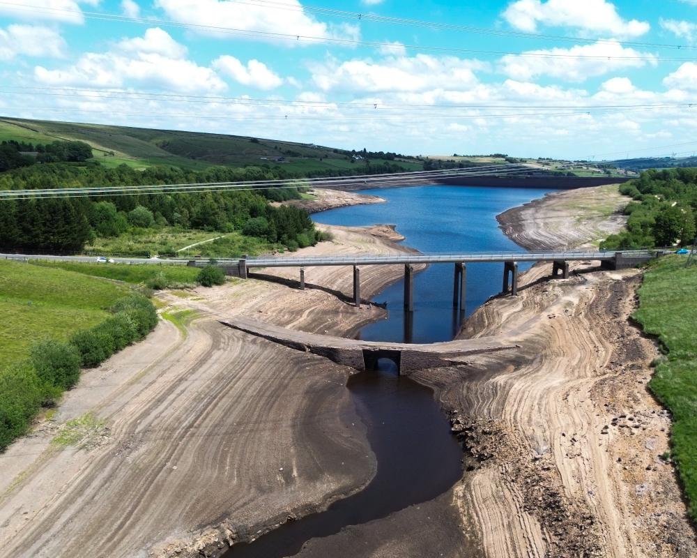 A scenic view of a river in England, with a description of the importance of water conservation and rainfall harvesting in the UK, highlighting the need for sustainable water management practices to protect the country's precious water resources