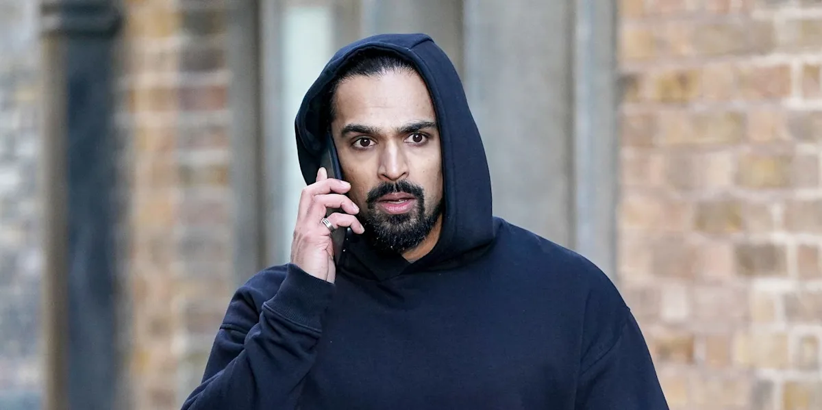 EastEnders Ravi secret exposed in early iPlayer release, a dramatic scene with a shocked expression, the colour palette is dark and ominous, hinting at the seriousness of the secret