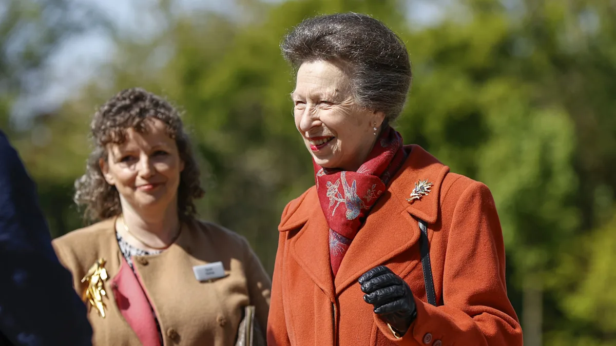 A picturesque view of the Queen Elizabeth II Garden, featuring a subtle yet meaningful corgi tribute, surrounded by beautiful flora and fauna, showcasing the monarch's love for nature and animals, with a focus on animal behaviour and nature conservation