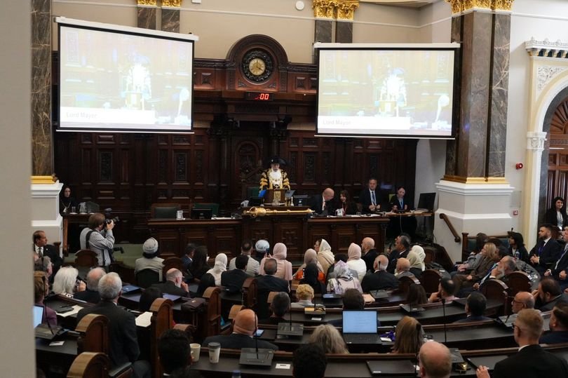 A photo of a Birmingham Council meeting, with a diverse group of people seated around a table, highlighting the importance of language and cultural inclusivity in public institutions, with a focus on the English language