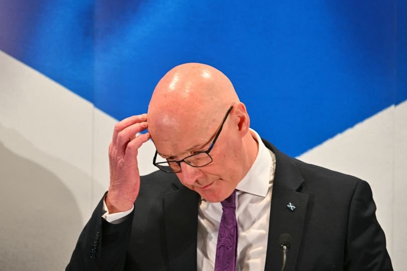 A descriptive image of the Scottish flag waving in the wind, symbolising the country's push for independence and self-determination, with a subtle background of the UK parliament, highlighting the complex relationship between Scotland and the rest of the UK