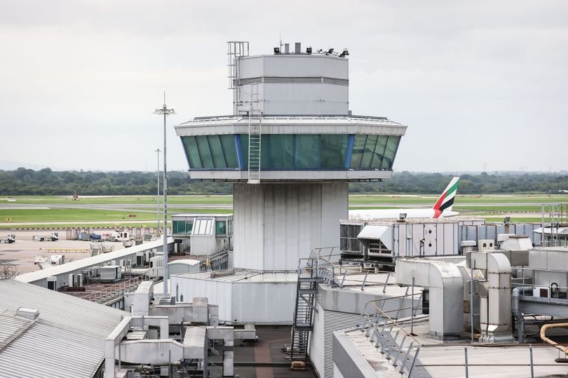 A featured image of Manchester Airport, with a focus on the security measures in place to ensure the safety and well-being of all passengers and staff, including customs officers and security personnel, with a primary keyword of airport security