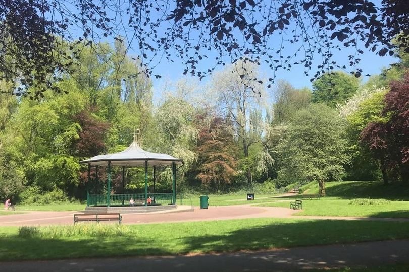 A sombre image of Willenhall park, with a police presence in the background, highlighting the seriousness of the racially aggravated pensioner attack