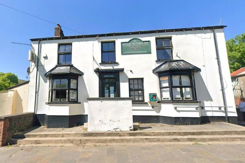 A historic pub building with a sign reading 'Est. 1820' being renovated into modern offices, highlighting the blend of old and new architecture with workers in hard hats and historical preservationists analysing the building's original features