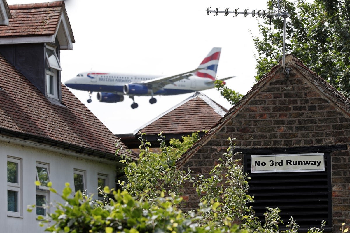 Aerial view of Heathrow Airport, with a new runway under construction, highlighting the potential impact on local communities and the environment, with a focus on Heathrow expansion