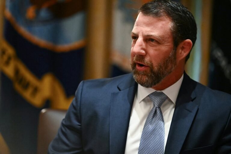 US customs agents at work in a busy airport, with a focus on Markwayne Mullin's proposal to withdraw agents from sanctuary cities, highlighting the potential impact on immigration and border control