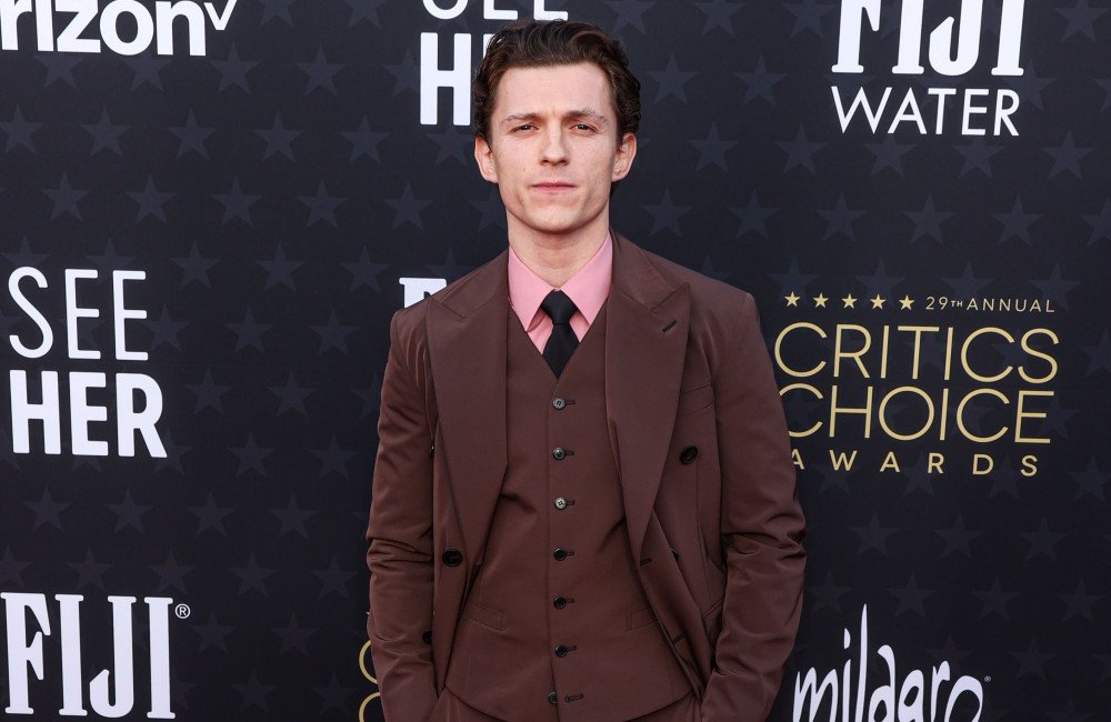 Tom Holland posing on the red carpet, looking dashing and charming, with a hint of his Spider-Man persona, showcasing his transformation from a party animal to a dedicated actor, with a focus on his journey to sobriety and growth