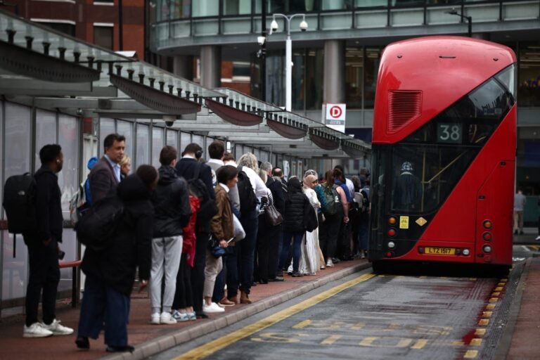 A crowded bus stop during a tube strike, with people waiting for alternative transport, highlighting the impact of transport disruption on daily commutes and the need to understand employee rights