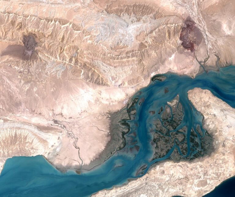 Aerial view of Qeshm Island, featuring its unique landscape and coastline, with the underground missile city hidden beneath the surface, showcasing Iran's military prowess and strategic location in the Strait of Hormuz, highlighting the island's stunning natural beauty and rich cultural heritage
