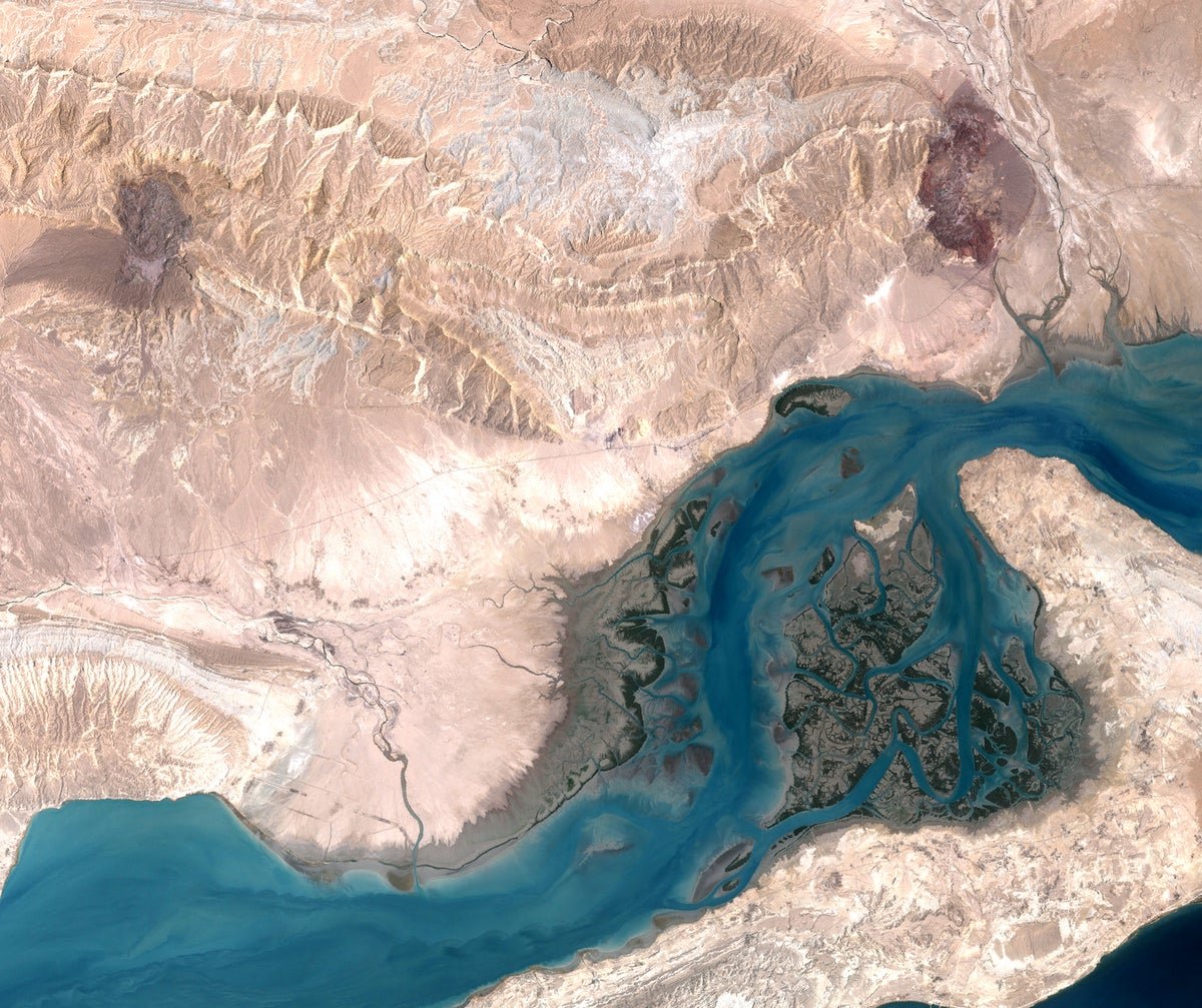 Aerial view of Qeshm Island, featuring its unique landscape and coastline, with the underground missile city hidden beneath the surface, showcasing Iran's military prowess and strategic location in the Strait of Hormuz, highlighting the island's stunning natural beauty and rich cultural heritage