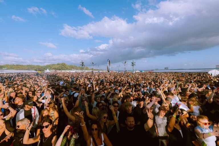 A group of people standing on the M6 highway, surrounded by cars and trucks, with a party atmosphere and music playing in the background, highlighting the primary keyword of M6 traffic chaos and the behaviour of stranded motorists