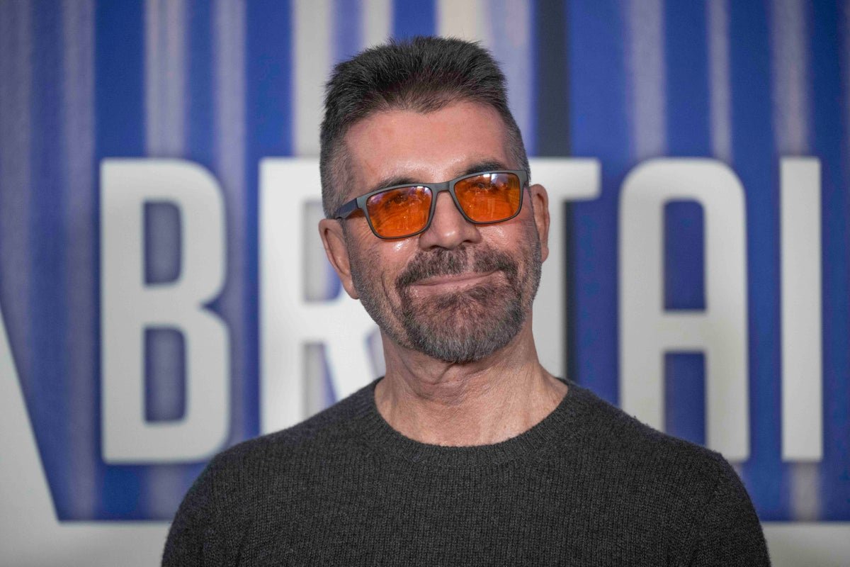 Simon Cowell standing on the Britain's Got Talent stage, with a sombre expression, surrounded by contestants and a colourful backdrop, highlighting the show's entertainment and reality TV aspects