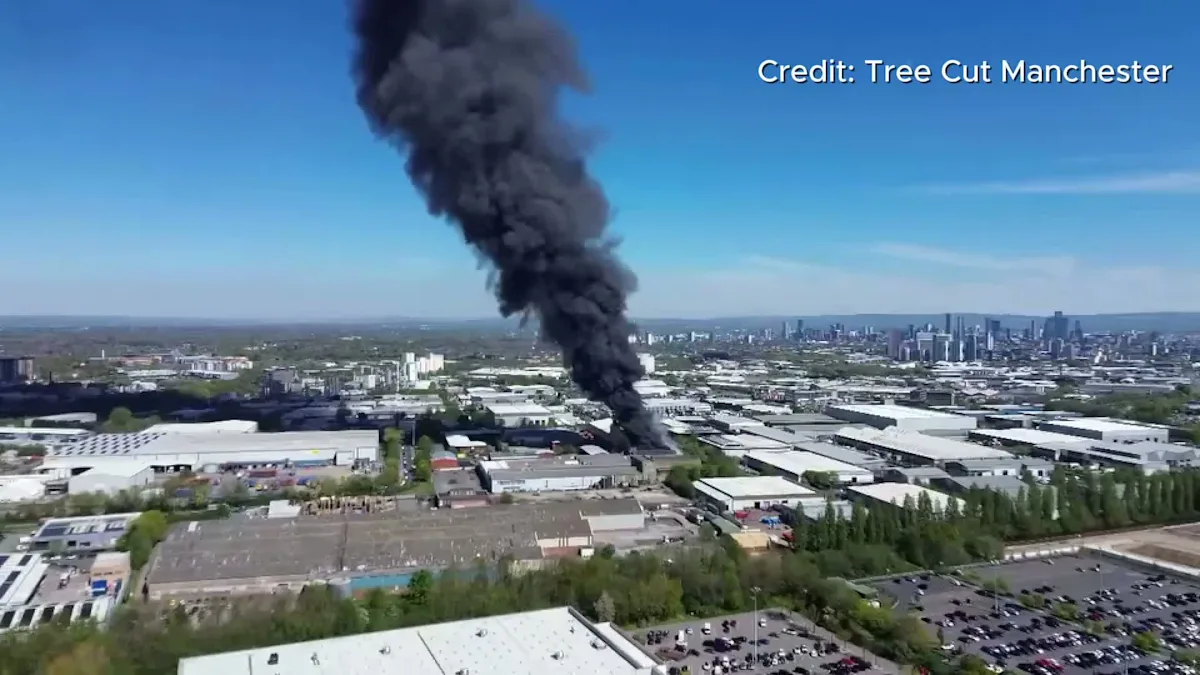 Aerial view of the Trafford Park fire, showing the extent of the damage and destruction caused by the blaze, with drone footage providing a unique perspective on the aftermath