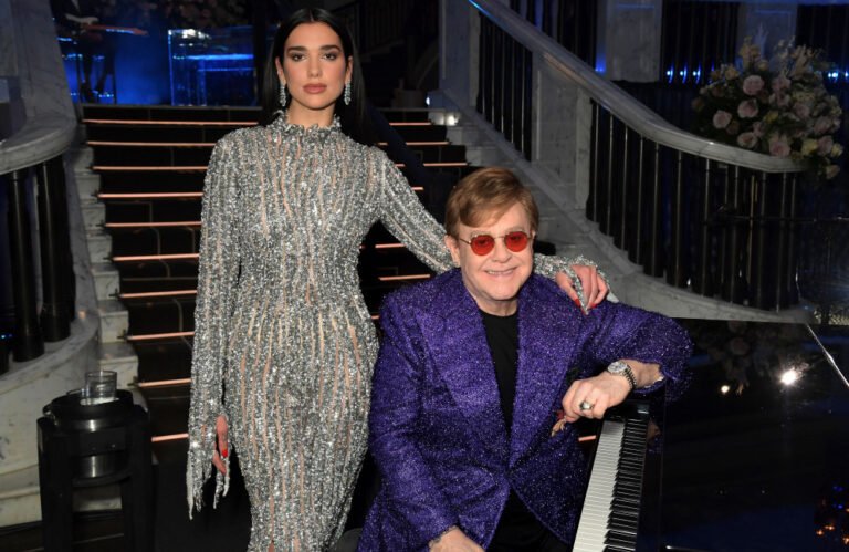 Dua Lipa and Callum Turner share a romantic kiss on their wedding day, surrounded by loved ones and with Sir Elton John in attendance, a truly unforgettable occasion with a touch of magic