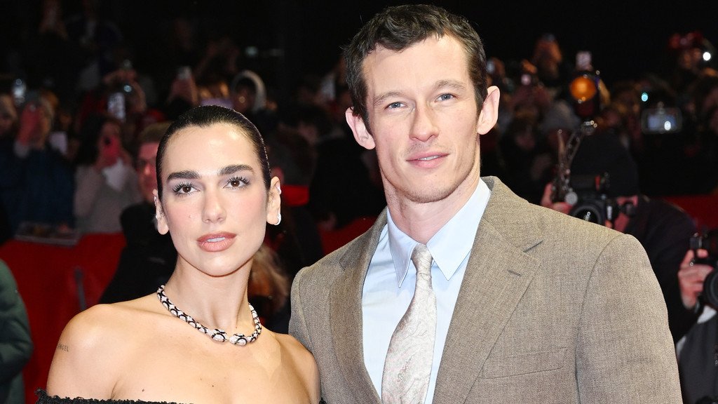 Dua Lipa and Callum Turner exchanging vows in a picturesque Sicilian landscape, surrounded by friends and family, with a beautiful blend of traditional and modern elements, featuring the primary keyword 'Dua Lipa wedding'