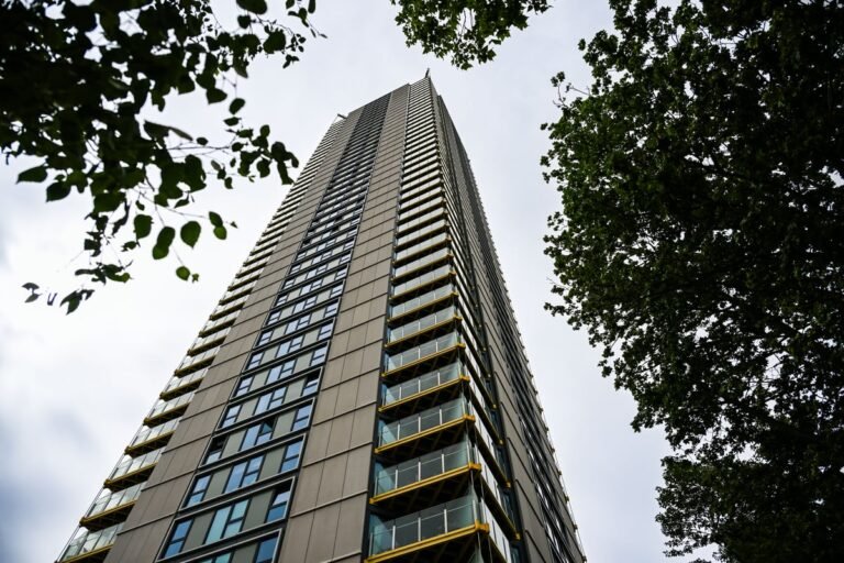 A luxury London tower block with a stunning city view, where a family of three tragically fell to their deaths from the 36th floor, highlighting concerns about high-rise safety and the need for increased support for families in need