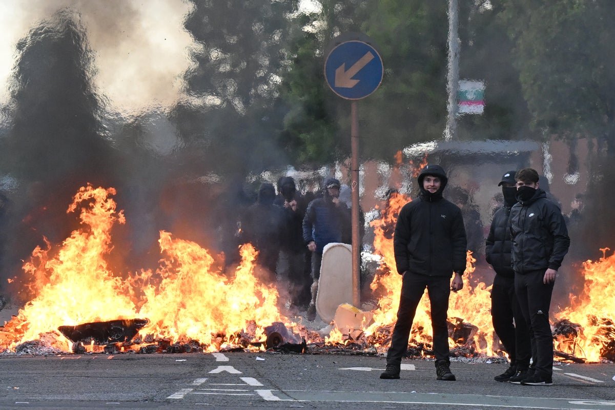 A descriptive image of a protest in Belfast, with a primary focus on the dangers of far-right extremism, highlighting the importance of addressing the root causes of this phenomenon and promoting tolerance, inclusivity, and respect for diversity