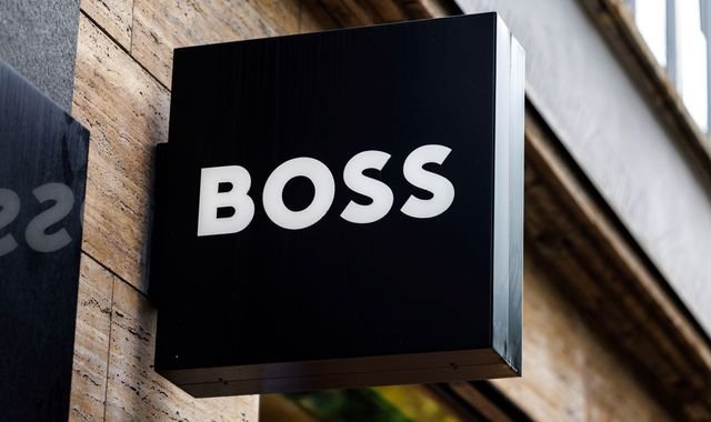 The Hugo Boss logo is seen outside a store, symbolising the brand's commitment to luxury fashion, as the Sports Direct owner launches a takeover bid to expand its portfolio in the competitive fashion industry