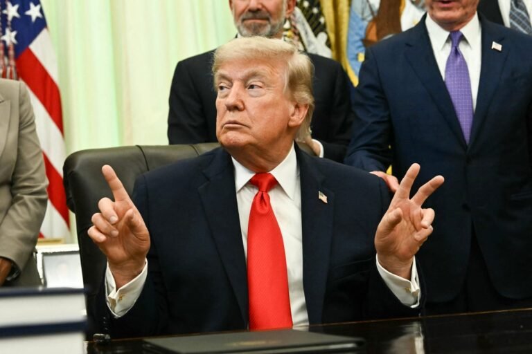 Photo of Trump signing seafood order with fishermen and fisherwomen in the background, highlighting the importance of inclusive language in the industry
