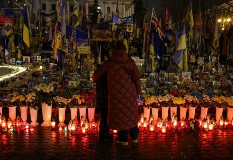 A young woman in a military uniform, with a solemn expression, standing in front of a Ukrainian flag, symbolising the conflict between Ukraine and Russia, with a focus on the recruitment of young women to target Ukrainian servicemen, highlighting the desperation of Russian forces and the need for international intervention