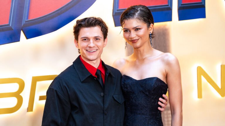 Tom Holland and Zendaya posing together, looking happy and in love, with a beautiful colour background, showcasing their stunning behaviour as a couple