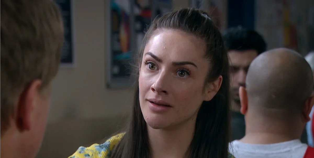 A dramatic scene from Emmerdale featuring Victoria Sugden and Moira, with a shocked expression on their faces, set against the vibrant colour palette of the village, with the primary keyword Emmerdale naturally included