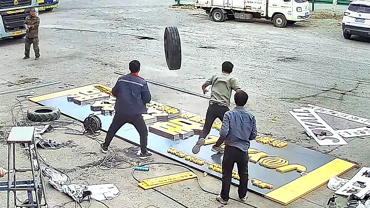 A runaway truck wheel is seen hurtling towards a group of workers in a shocking near-miss incident caught on CCTV, highlighting the importance of road safety and regular vehicle maintenance to prevent such accidents