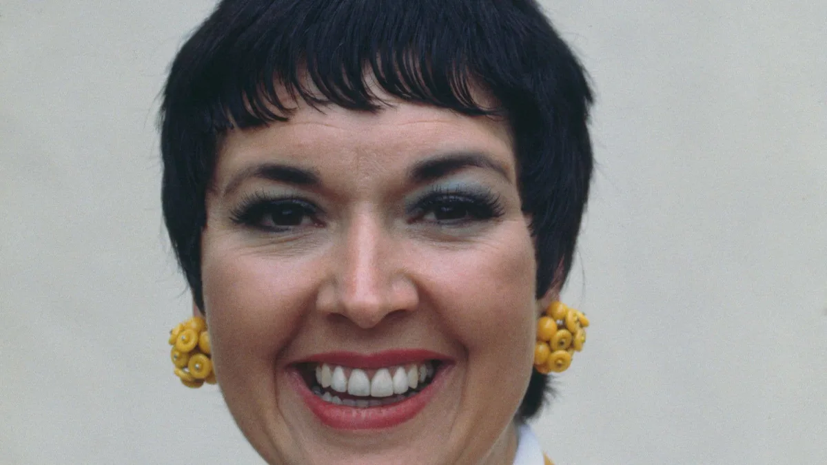 Ruth Madoc and her famous ex-husband, a recognisable figure in the entertainment industry, posing together at a public event, with a mix of colour and vibrancy