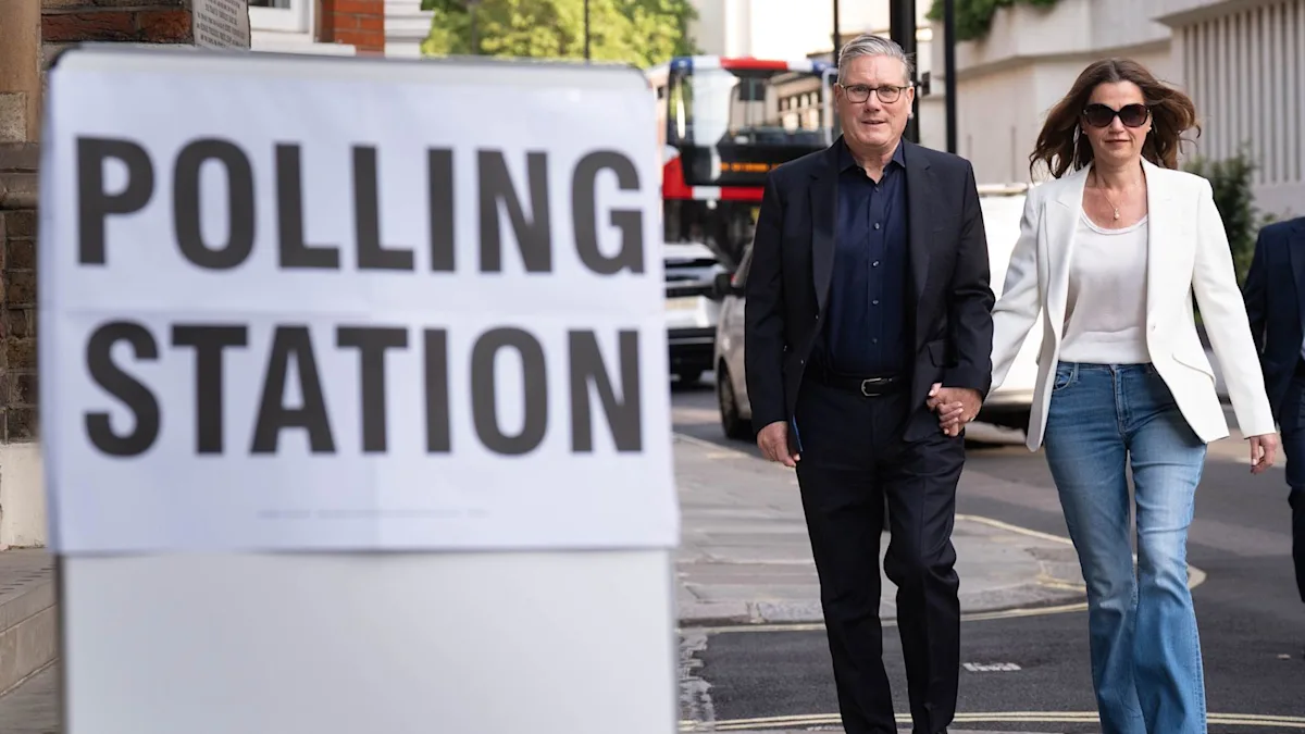 Keir Starmer speaking at a Labour Party conference, surrounded by MPs and party members, with a mix of supportive and dissenting voices, highlighting the leadership crisis and the need for unity and stability in the party