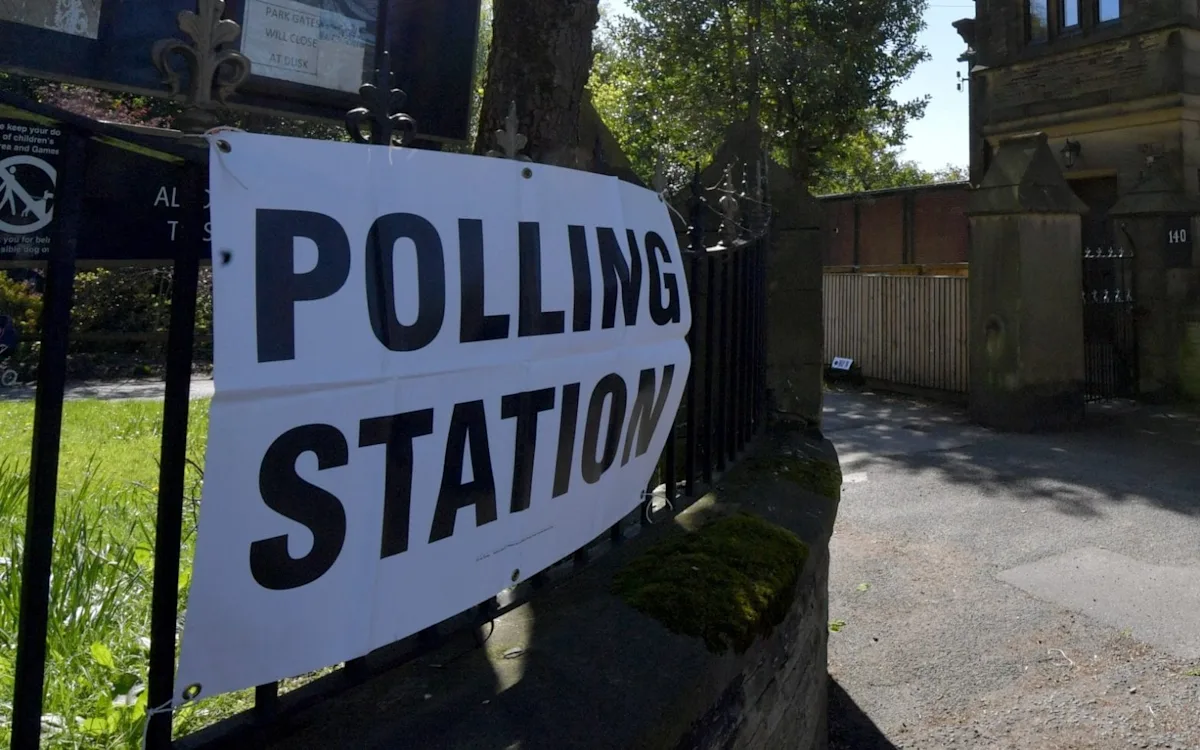Police officers investigating election fraud in Tameside, with a focus on ensuring the integrity of the electoral process and preventing fraudulent behaviour, as part of a wider effort to maintain public trust in the system