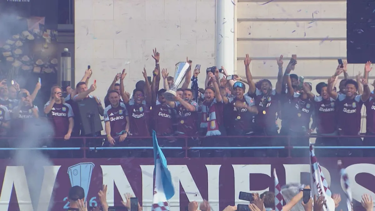 Aston Villa players and fans celebrate the team's Europa League win with a victory parade in Birmingham, featuring colourful floats and cheering crowds, with the primary keyword being Aston Villa