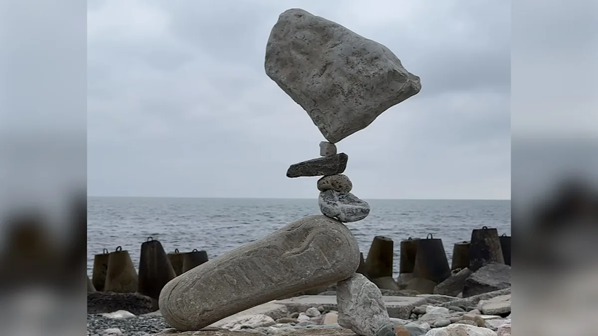 A man carefully balances rocks on top of each other, creating a towering structure that seems to defy gravity, with the sun shining down and a serene natural backdrop, showcasing the primary keyword of rock balancing in a truly breathtaking setting