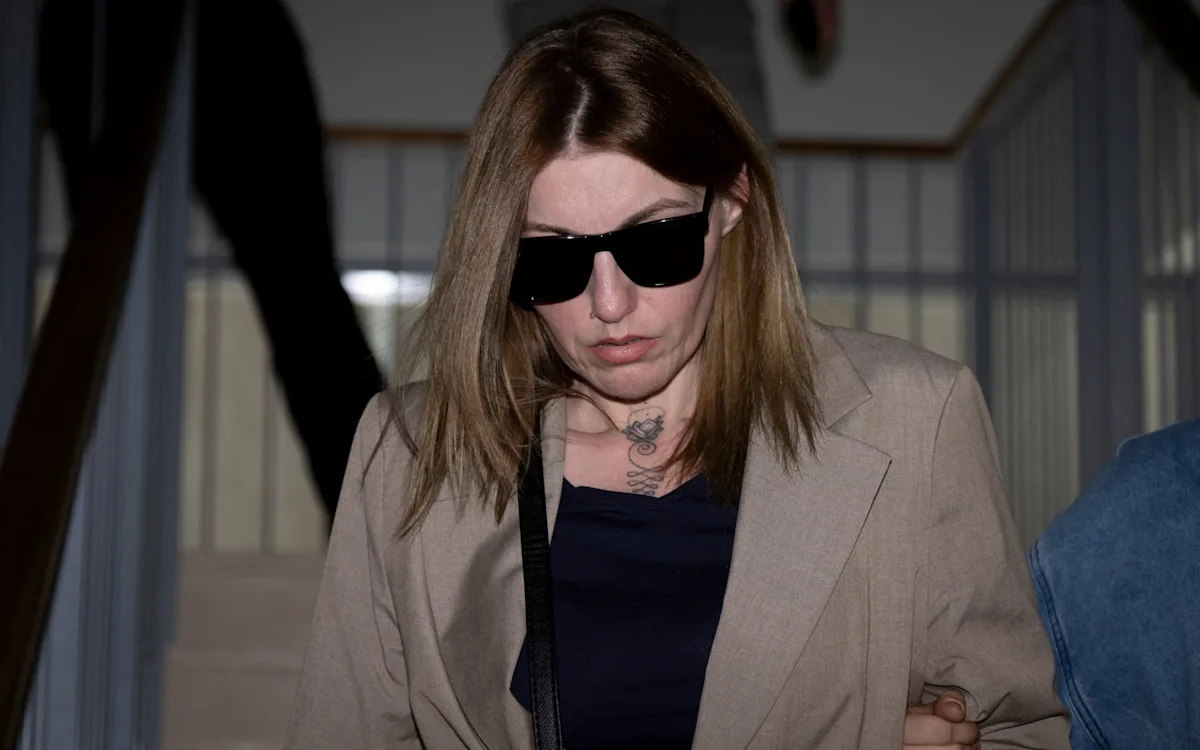 A photo of a person in handcuffs with a blurred face, symbolising the banker's shameful exploitation of his girlfriend, which led to his imprisonment for pimping and human trafficking crimes
