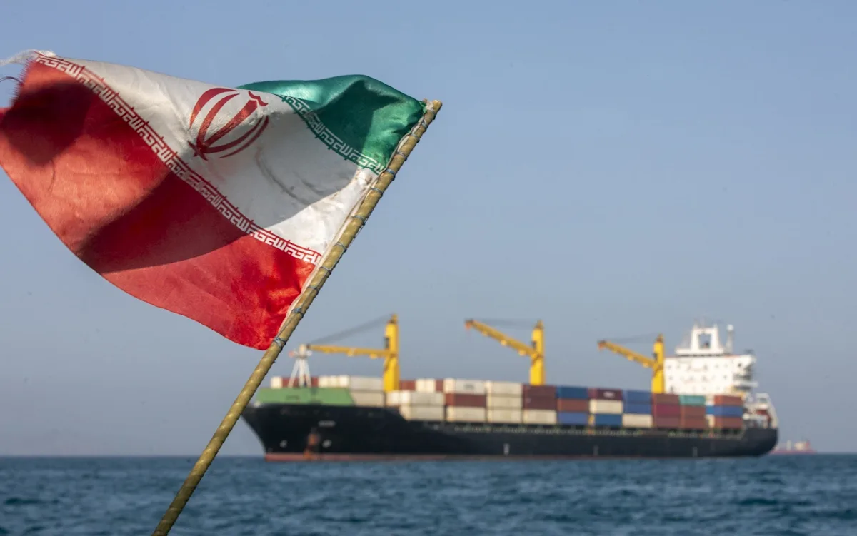 Iran and US flags waving together, symbolising the historic deal to surrender uranium and open Hormuz, a major development in international relations and global politics