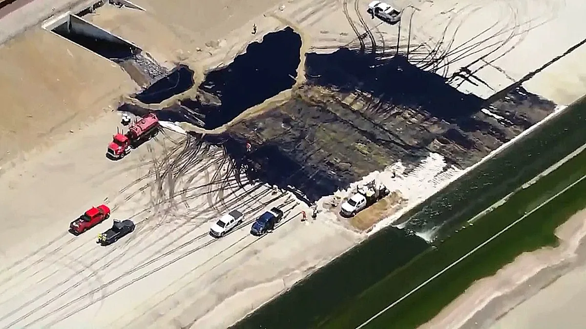 Aerial view of the LA River oil spill, with oil leaking from a ruptured pipeline into the water and surrounding streets, highlighting the devastating impact of the environmental disaster on the local ecosystem