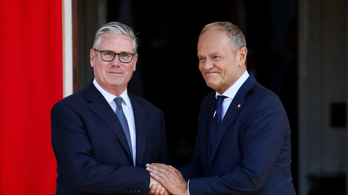 UK and Poland leaders shake hands after signing defence pact, marking a new era in bilateral relations and cooperation in defence and security matters, with a focus on counter-terrorism and cybersecurity