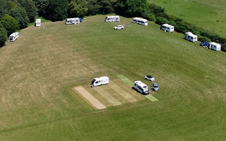 Travellers have taken over a local cricket field, setting up camp with their caravans and vehicles, highlighting the need for more facilities and services to cater to their needs, with the primary keyword being travellers