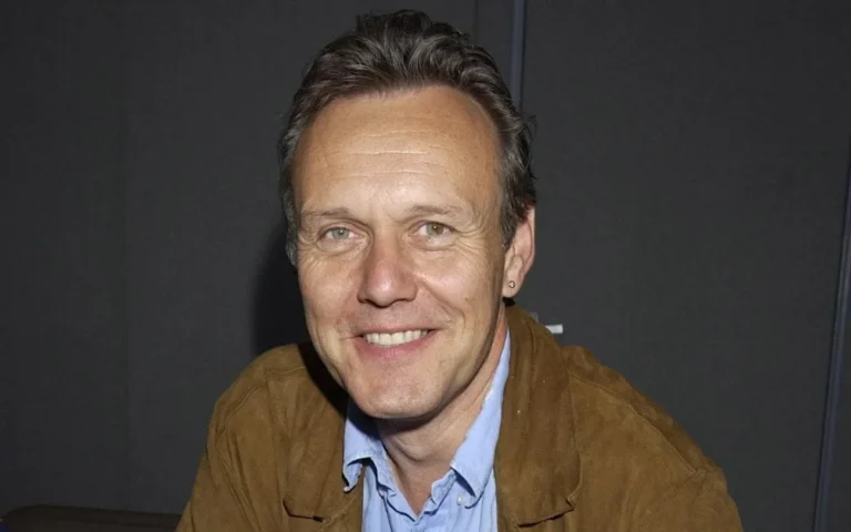 Anthony Head as the Gold Blend man, a iconic figure in coffee advertisements, with a warm and charming smile, bringing joy and entertainment to audiences across the UK, with his smooth voice and captivating on-screen presence