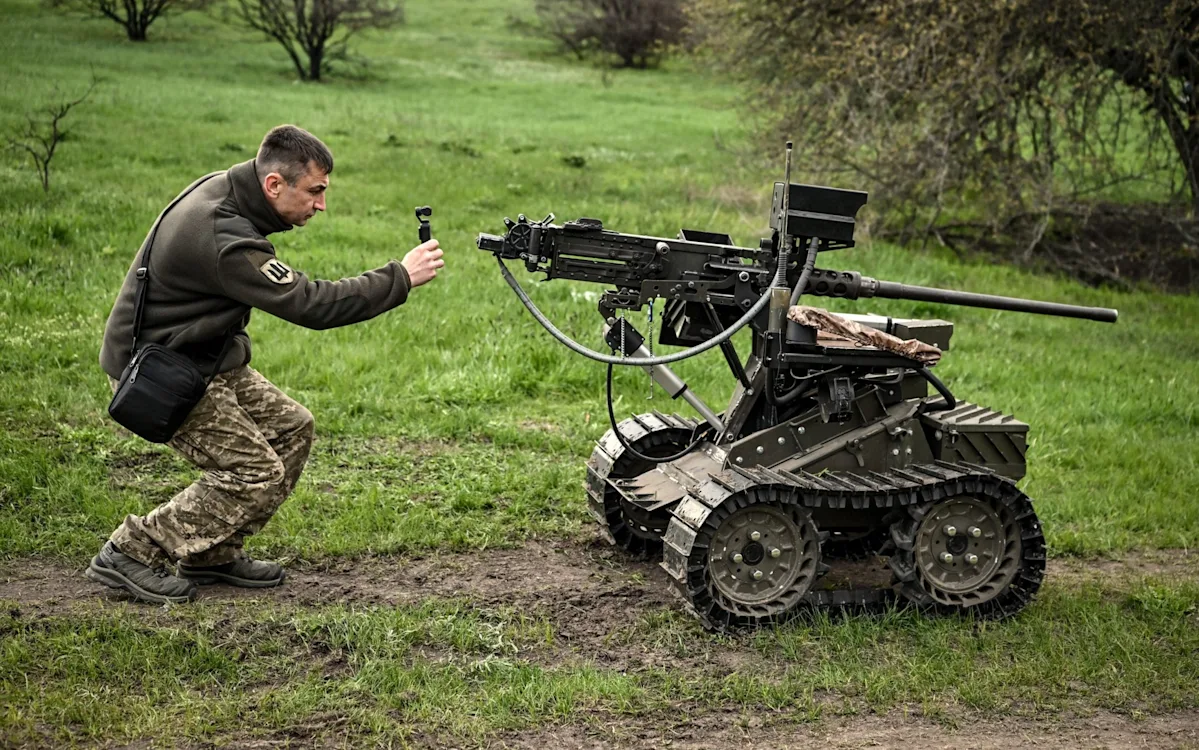 Ukrainian soldiers operating military equipment, with a focus on the country's growing defence industry and its implications for national security, including the production of tanks, artillery systems, and small arms, in the context of the ongoing conflict with Russian-backed separatists